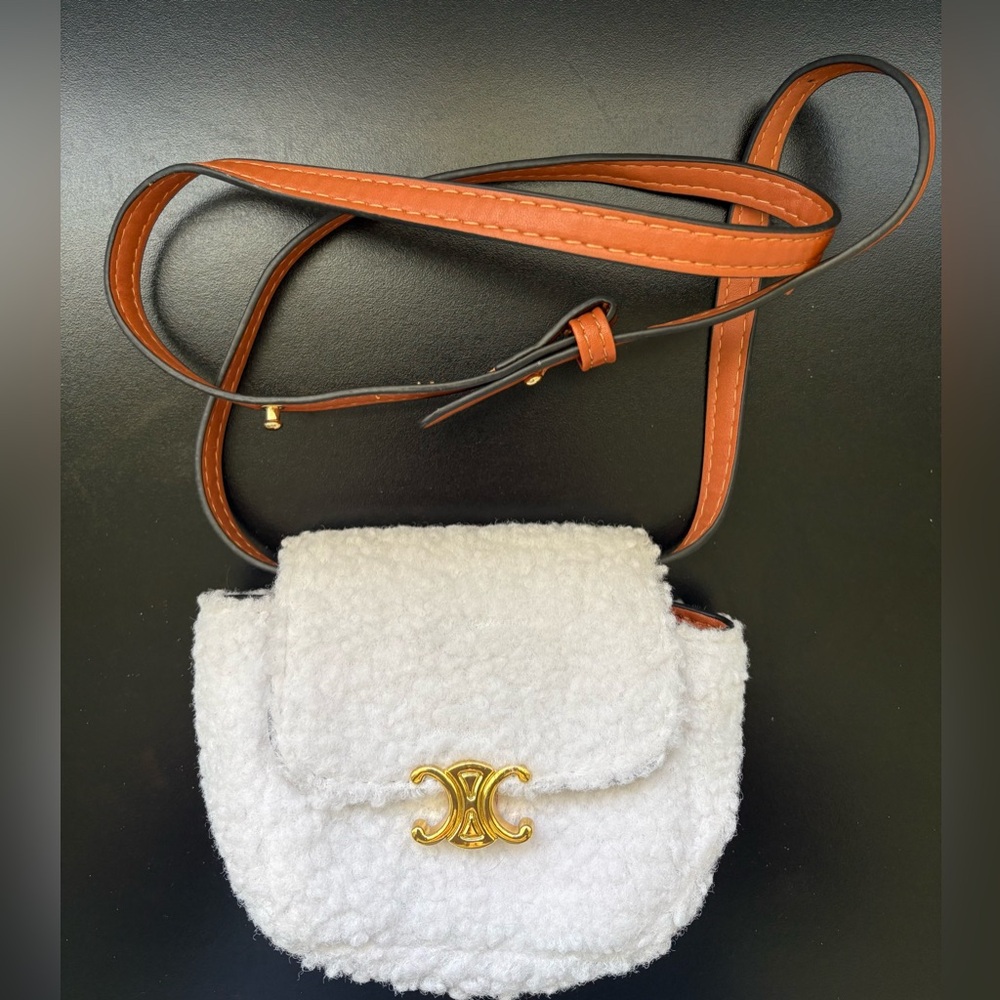 White Faux Shearling Crossbody Bag with Gold Accent and brown adjustable strap.